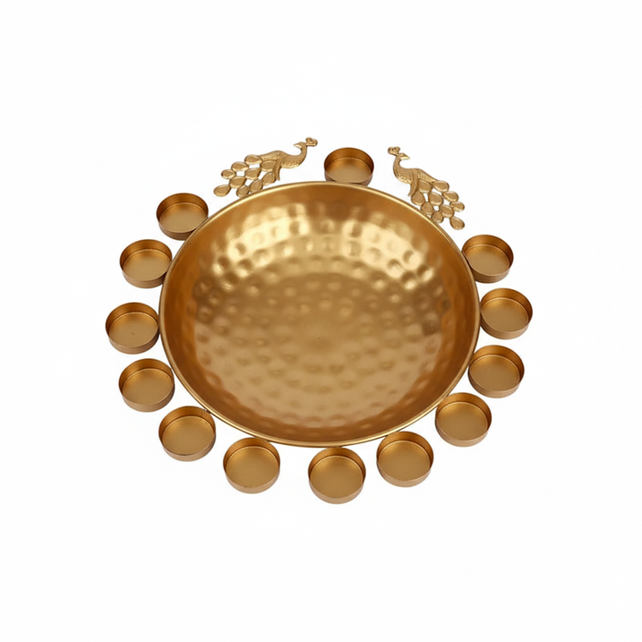 Golden metal peacock urli bowl with 12 diyas
