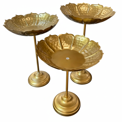 Set of three hammered golden lotus- shaped bowls on tall stands